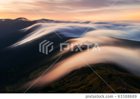 Amazing flowing morning fog in spring mountains 63388689