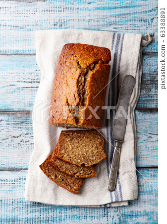 Healthy vegan oat and banana loaf bread, cake. Blue wooden background. Top view. 63388891