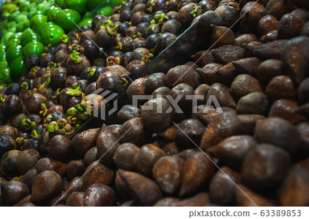 Plenty of fresh Salak fruits on a counter in a market Plenty of fresh Salak fruits on a counter in a market 63389853