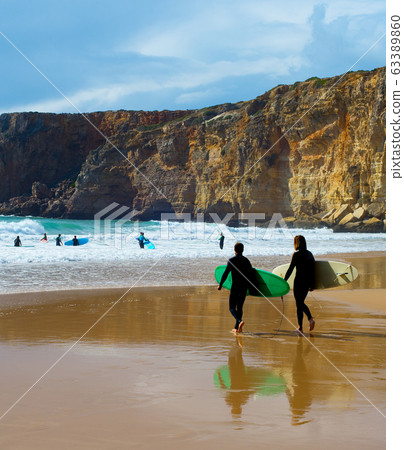 Surfers surfboards beach Portugal cliff Surfers surfboards beach Portugal cliff 63389860