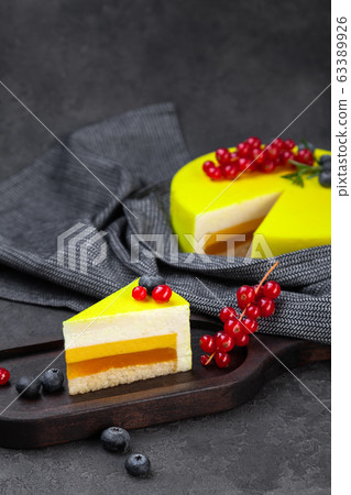 Souffle lemon layer yellow cake and piece on wooden plate Souffle lemon layer yellow cake and piece on wooden plate 63389926