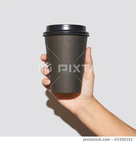 Girl hand hold coffee plastic cup 63390191