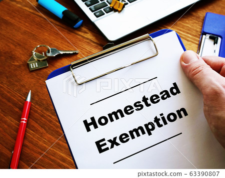 Man is reading Homestead Exemption at the home. 63390807