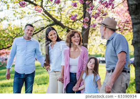 Three generation family on a walk outside in spring nature. Three generation family on a walk outside in spring nature. 63390934