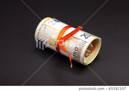 euro money in a red ribbon on black euro money in a red ribbon on black 63392107