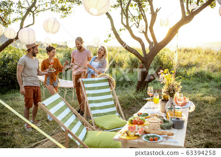 Friends on a picnic in the garden 63394258