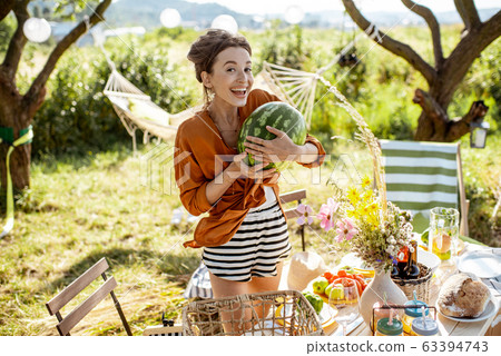 Woman preparing for the festive dinner outdoors 63394743