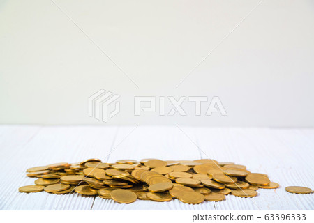 Piles of coins on white wood working table, Piles of coins on white wood working table, 63396333