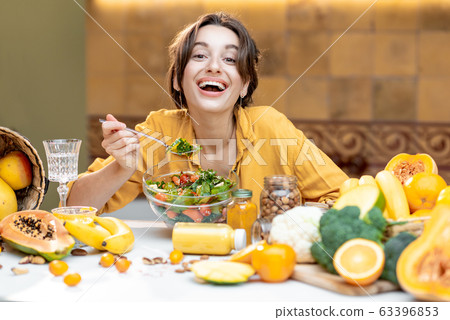 Young woman with healthy fresh food on the kitchen 63396853