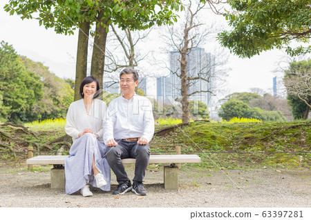 Refreshing forest park Senior couple feeling the spring Rape field in the back 63397281