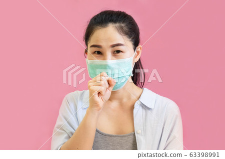 Young asian woman worea gray tank top, Blue shirt and protective masks against virus and air pollution,make gesture Coughing, isolated on pink background Young asian woman worea gray tank top, Blue shirt and protective masks against virus and air pollution,make gesture Coughing, isolated on pink background 63398991