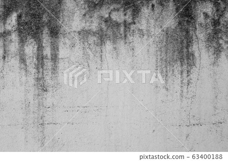 Close-up of White cement crack wall and peeled paint caused by water and sunlight. Peel wall of White house paint with black stain. Black and White of Texture background. Close-up of White cement crack wall and peeled paint caused by water and sunlight. Peel wall of White house paint with black stain. Black and White of Texture background. 63400188