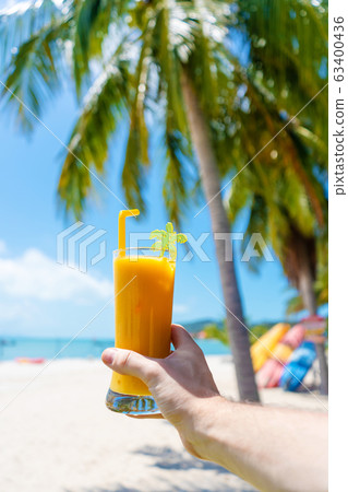 First-person view. Girl holds a glass cup of cold 63400436
