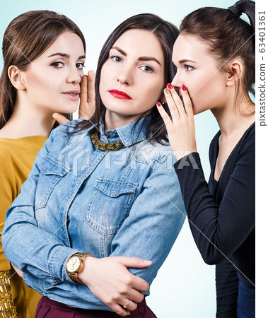 Young girls gossiping some secret. 63401361