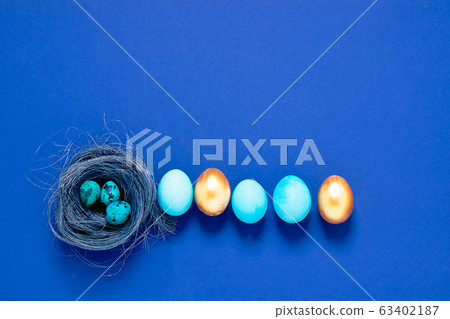 Happy easter concept. Festive spring composition blue small big eggs in a nest on a fashionable minimalistic background. 63402187