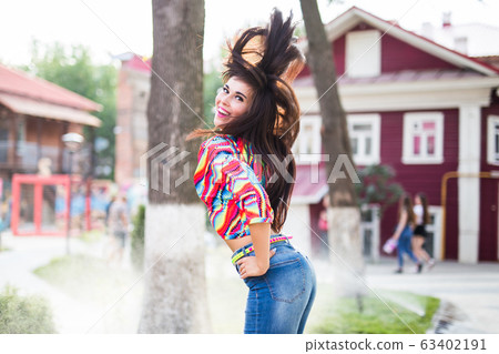Beautiful attractive young woman having fun and enjoying and dancing in the park on a sunny summer day. Beautiful attractive young woman having fun and enjoying and dancing in the park on a sunny summer day. 63402191