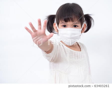 Asian little cute girl 4 years old wearing a hygienic face mask to protective spread the disease on white background. Prevention of spreading the corona virus COVID-19 cold flu or pollution. 63403261