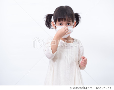 Asian little cute girl 4 years old wearing a hygienic face mask to protective spread the disease on white background. Prevention of spreading the corona virus COVID-19 cold flu or pollution. 63403263