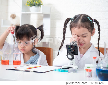 Two little asian sibling girl role playing a scientist in science lab with equipment. Learning and education of kid. Two little asian sibling girl role playing a scientist in science lab with equipment. Learning and education of kid. 63403266