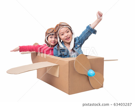 Asian siblings cute girl playing cardboard airplane isolated on white background with clipping path. Two Asian children play as pilot on cardboard airplane DIY. Asian siblings cute girl playing cardboard airplane isolated on white background with clipping path. Two Asian children play as pilot on cardboard airplane DIY. 63403287