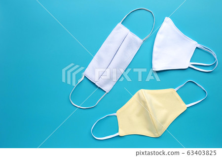 Handmade white cloth masks on blue  63403825