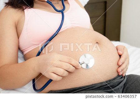 Happy pregnant woman and expecting baby at home. 63406357
