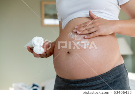 Happy pregnant woman and expecting baby at home. 63406433