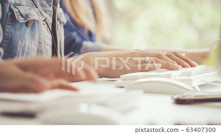 Businesswoman hand typing on computer at desk. 63407300