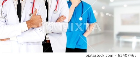 Doctor working in hospital with other doctors. 63407463