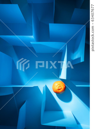Tangerine in paper labyrinth. Concept of theme of 63407677