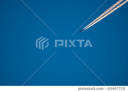 Jet plane trail crossing the sky from top right to bottom left 63407728