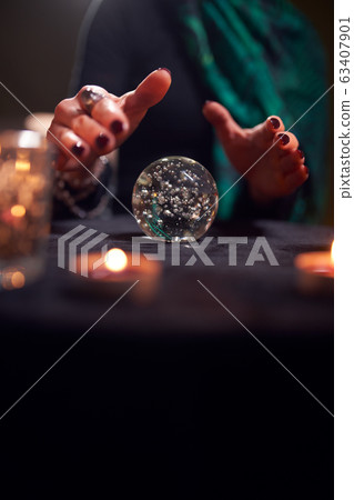 Close-up of hands of unrecognizable fortune-teller with ball of predictions 63407901