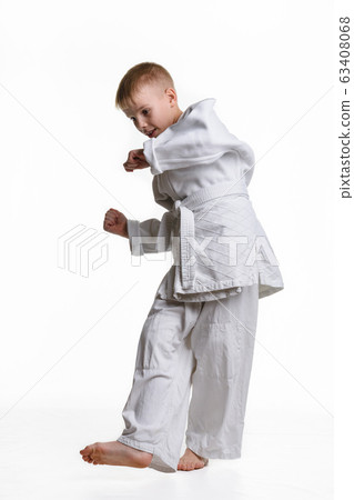 Judo boy practicing to do a sweep 63408068