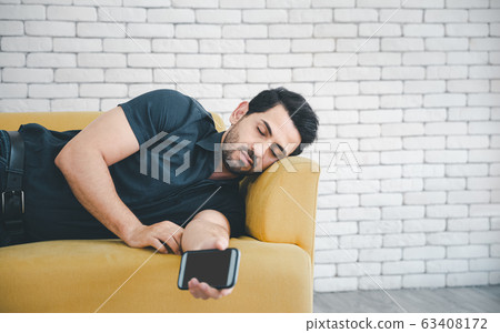 man napping with smart phone man napping with smart phone 63408172