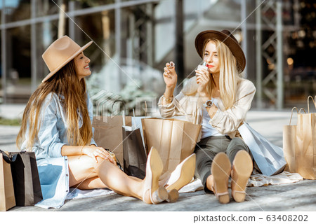 Women with shopping bags near the mall outdoors 63408202