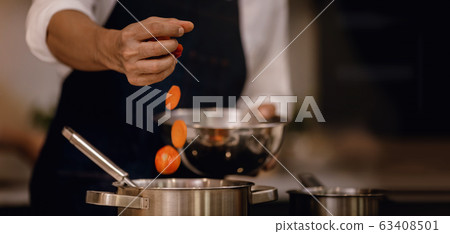 Chef Cooking Food in the Modern Kitchen. Closeup Chef Cooking Food in the Modern Kitchen. Closeup 63408501
