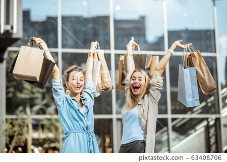 Women with shopping bags near the mall outdoors Women with shopping bags near the mall outdoors 63408706