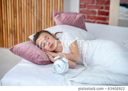 Teen girl sleeping in a big bed. Teen girl sleeping in a big bed. 63408922