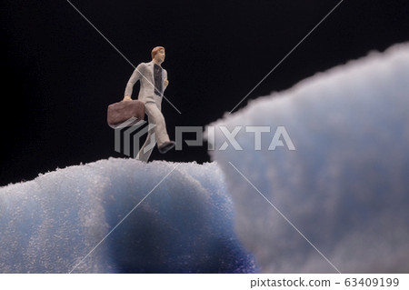 Businessman about to fall into hole 63409199