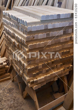 Wooden table legs. Stacked wooden table legs in workshop Wooden table legs. Stacked wooden table legs in workshop 63410280
