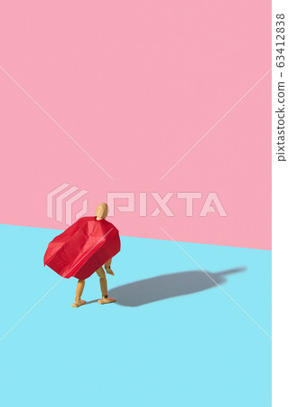 Wooden mannequin model in a red cape as a superhero with shadow. 63412838