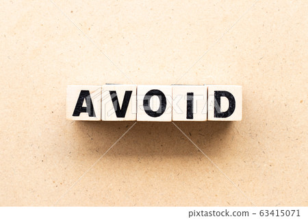 Letter block in word avoid on wood background 63415071