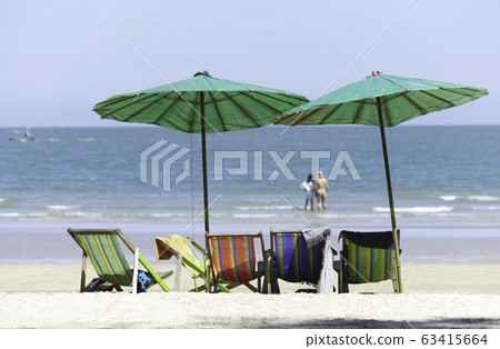 canvas bed and umbrellas on the beach Background Blurry Tourism and sea. 63415664