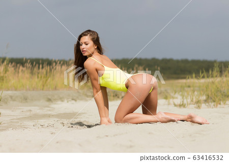 Sexy female in bright swimsuit on beach 63416532