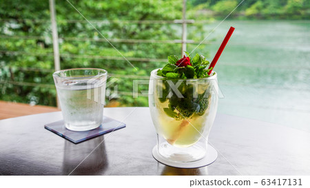 Fresh drinks with herbs and mini roses at a hotel on a lush river Fresh drinks with herbs and mini roses at a hotel on a lush river 63417131