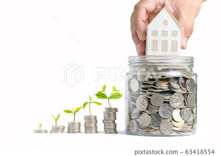 Growing Money - Hand man holding house model on Growing Money - Hand man holding house model on 63418554