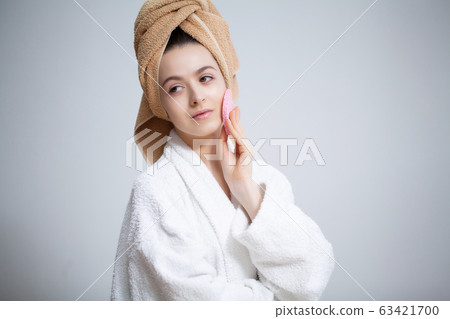 Cute woman makes makeup to the face in the bathroom Cute woman makes makeup to the face in the bathroom 63421700