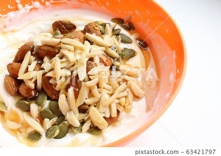 Healthy lifestyle breakfast in orange bowl close up 63421797