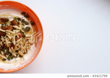 Healthy lifestyle breakfast in orange bowl, half 63421799