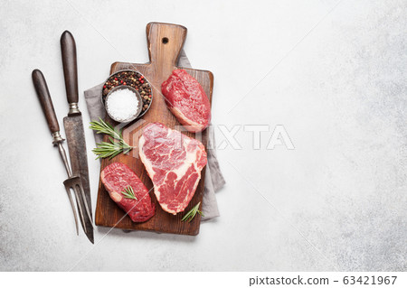 Variety of raw beef steaks 63421967
